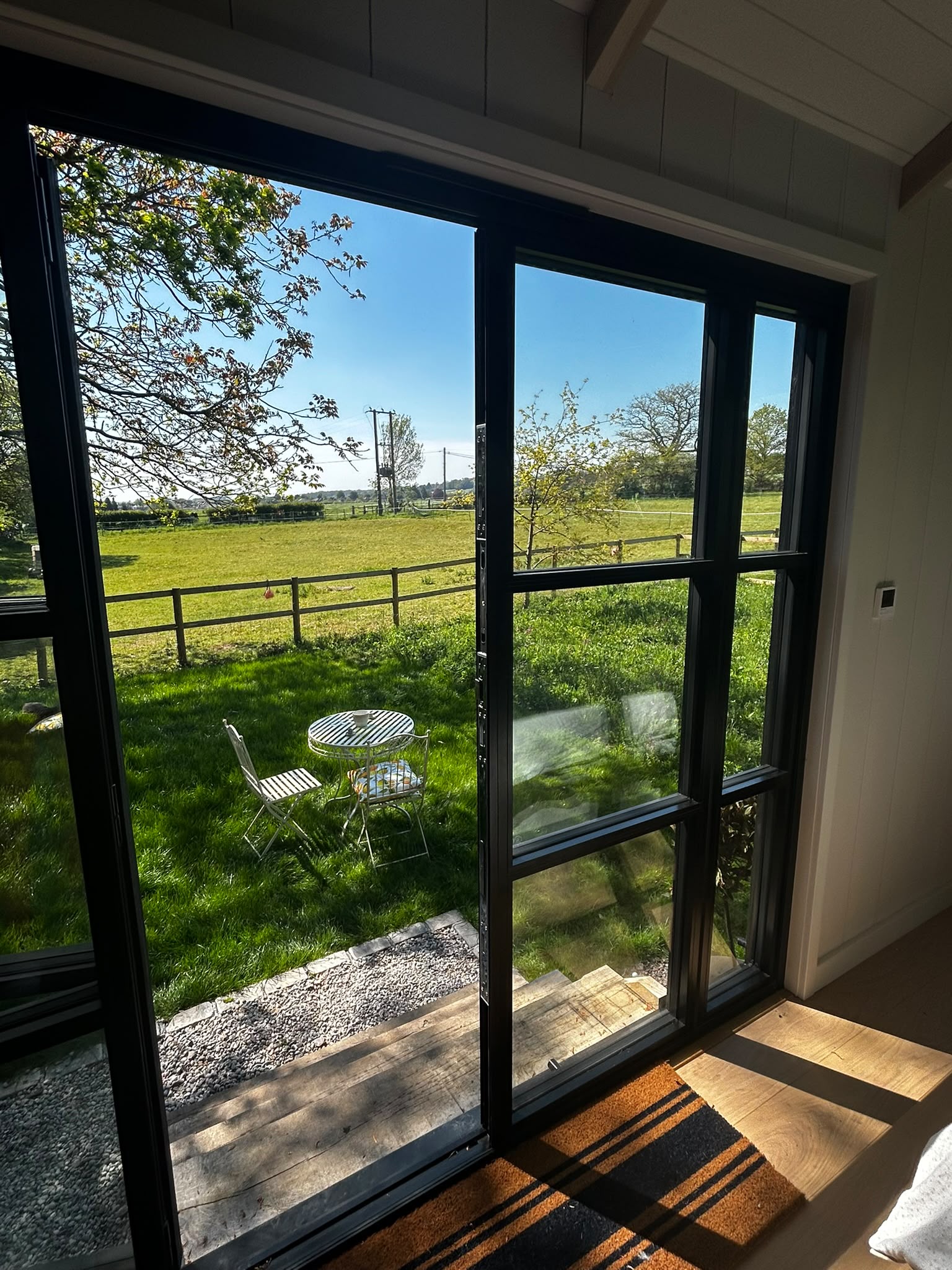 View across the paddocks from the hut's glass doors